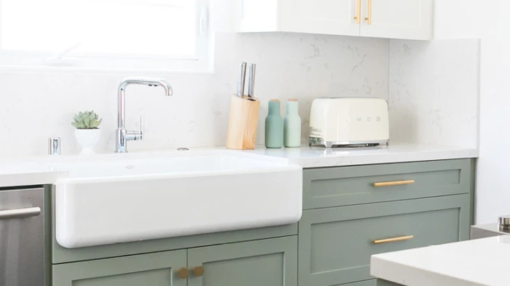 Porcelain sink with sage green cabinets and Torquay quartz countertops