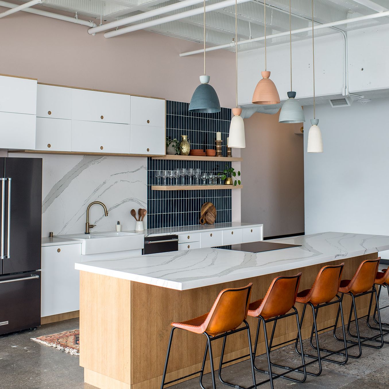 A kitchen with a wood floor
Description automatically generated