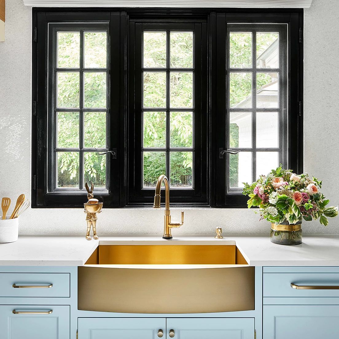 A kitchen with a sink and a window
Description automatically generated