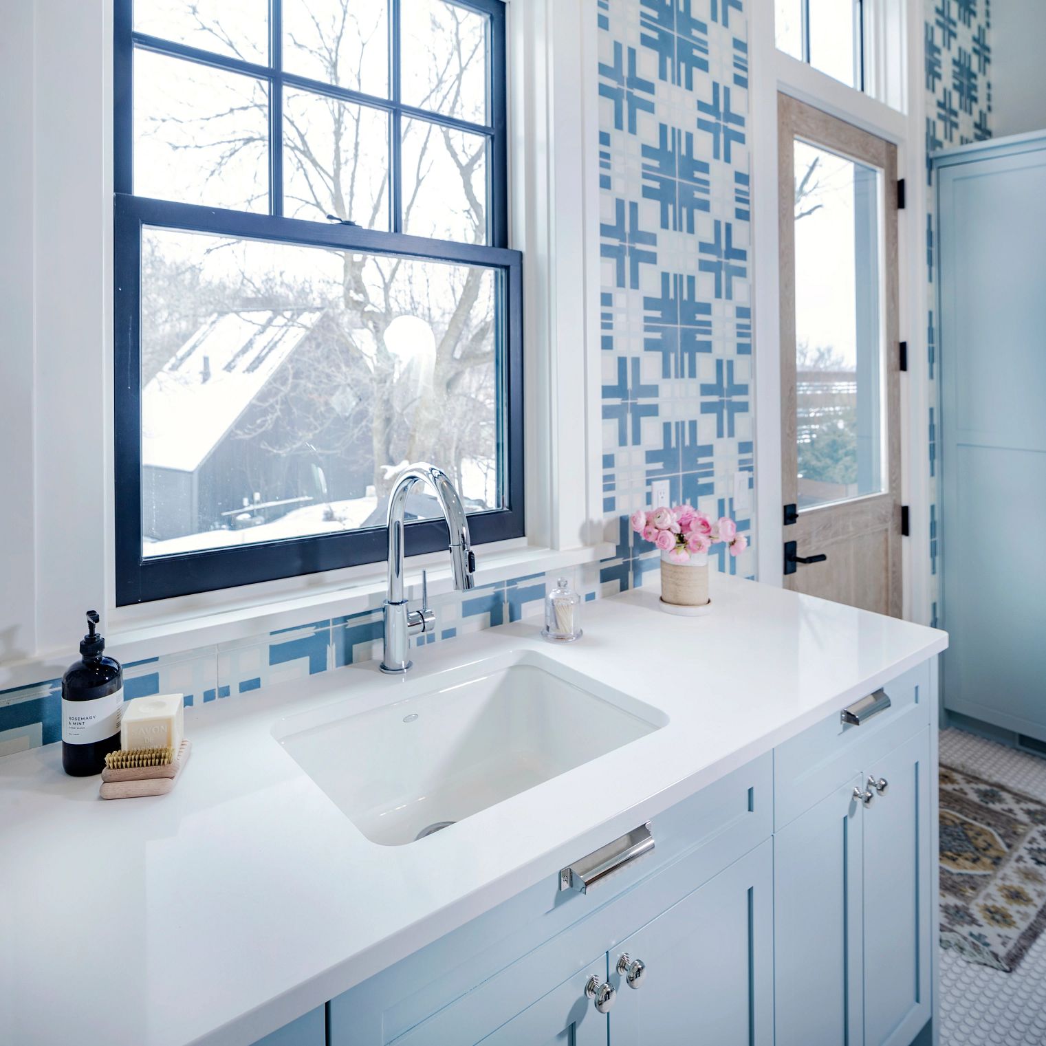 A bathroom with a sink and a window
Description automatically generated with low confidence