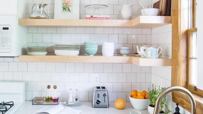 a tiny kitchen with floating wooden shelves and Ella quartz countertops