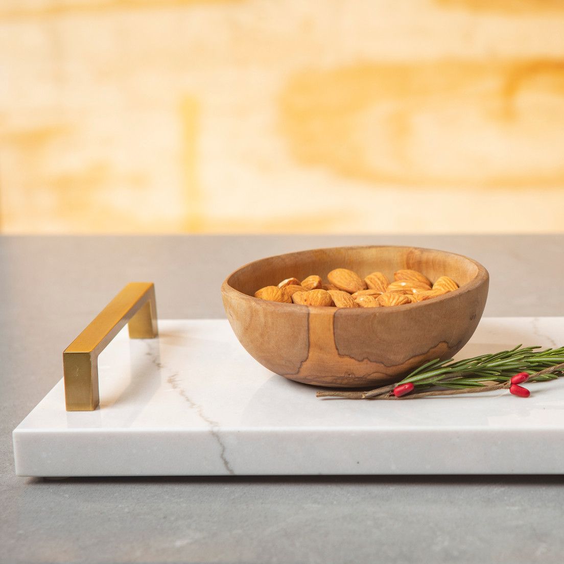 Cambria tray with handles with almonds in a wooden bowl on top.