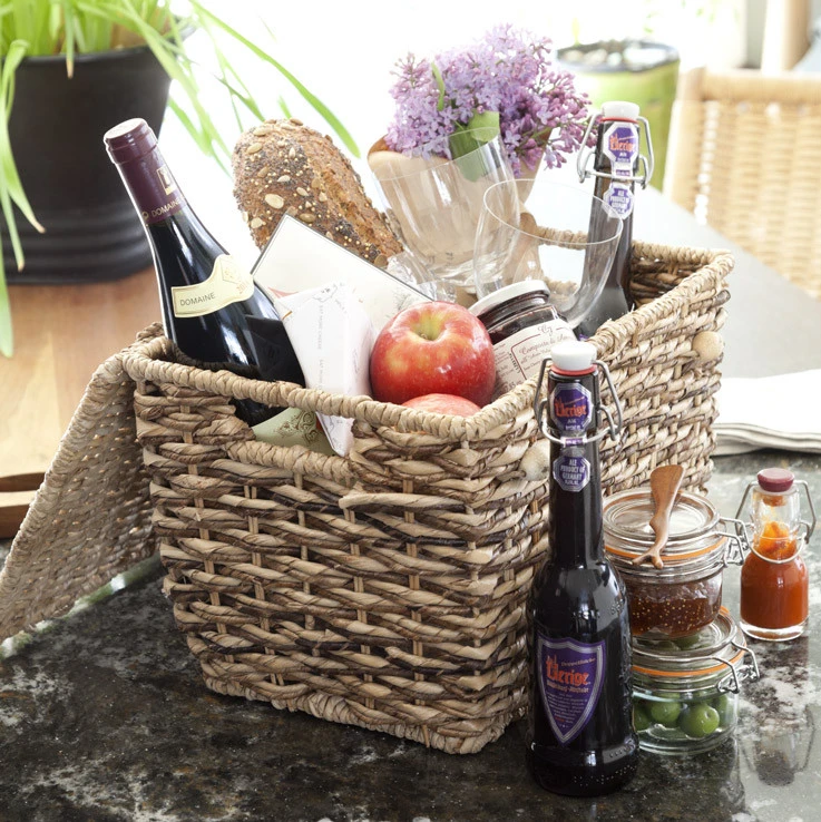 picnic basket with wine, bread, and fruit inside.