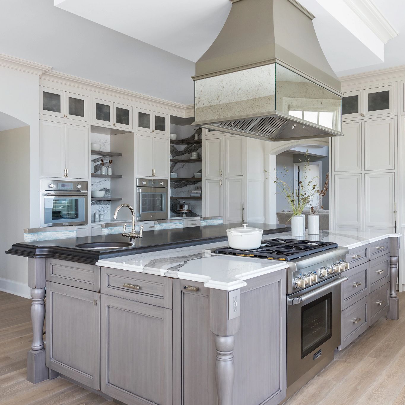 A kitchen with a wood floor
Description automatically generated