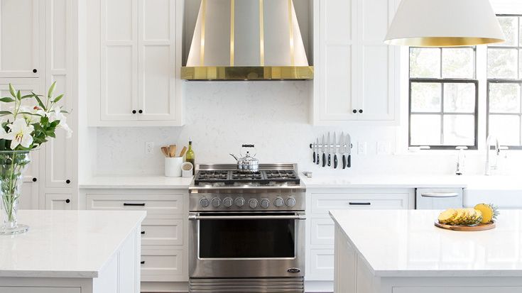 a bright white kitchen with two kitchen islands with Torquay quartz countertops